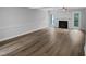 Spacious living room featuring wood floors, a fireplace, neutral paint, and a door to the backyard at 1432 Quarter Pt, Raleigh, NC 27615