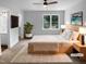 Staged primary bedroom featuring a large window, ceiling fan, and closet at 1432 Quarter Pt, Raleigh, NC 27615
