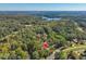 Aerial view showcasing the home's location nestled among trees and near a lake at 146 Wood Wedge, Sanford, NC 27332