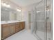 Bright bathroom featuring a double vanity, and a glass-enclosed shower with tiled walls at 146 Wood Wedge, Sanford, NC 27332