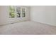 Spacious bedroom with plush carpet flooring and three large windows offering ample natural light at 146 Wood Wedge, Sanford, NC 27332