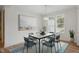 Elegant dining area featuring modern light fixture, large art, and windows with natural light at 146 Wood Wedge, Sanford, NC 27332