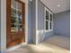 Inviting entryway featuring a beautiful glass front door with sidelights and classic light blue siding at 146 Wood Wedge, Sanford, NC 27332