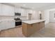 Modern kitchen with stainless steel appliances, white cabinets and countertops, and a wooden island at 146 Wood Wedge, Sanford, NC 27332