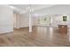 Open living space with beautiful wood flooring, many windows, and access to the modern kitchen at 146 Wood Wedge, Sanford, NC 27332