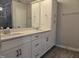 Bathroom with double sinks, white quartz countertops, and white shaker cabinets at 3006 Freewinds Way # 41, Cary, NC 27519