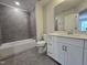 Modern bathroom featuring a shower over a tub, white vanity, and neutral tile flooring at 3006 Freewinds Way # 41, Cary, NC 27519