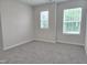 Carpeted bedroom with two windows showing an abundance of natural light at 3006 Freewinds Way # 41, Cary, NC 27519