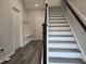 Inviting entryway with stylish staircase, wood flooring, and built-in storage bench at 3006 Freewinds Way # 41, Cary, NC 27519