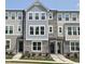 Charming townhome featuring stone accents, a well-manicured lawn, and a welcoming front entrance at 3006 Freewinds Way # 41, Cary, NC 27519