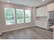 Bright dining area with white cabinets, stainless steel appliances, and natural light at 3006 Freewinds Way # 41, Cary, NC 27519