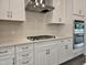 Kitchen with stainless steel appliances, stylish backsplash, and stone countertops at 3006 Freewinds Way # 41, Cary, NC 27519