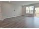 Spacious living area with wood floors, a large window, and a sliding glass door at 3006 Freewinds Way # 41, Cary, NC 27519