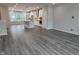 Open floor plan living area with wood floors, white kitchen, island, and large windows at 3006 Freewinds Way # 41, Cary, NC 27519