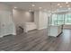 Living room with wood floors, a staircase, cabinets, and a kitchen island at 3006 Freewinds Way # 41, Cary, NC 27519