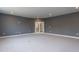 This basement area offers neutral carpet, double glass doors, recessed lighting, and space for entertaining at 111 Gaines Trail, Pittsboro, NC 27312