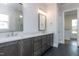 Modern bathroom featuring a double vanity with stone countertop, and a large mirror at 111 Gaines Trail, Pittsboro, NC 27312