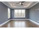 Comfortable bedroom with hardwood floors and large windows offering scenic outdoor views at 111 Gaines Trail, Pittsboro, NC 27312