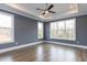 This bedroom features hardwood floors, recessed lighting, a ceiling fan, and large windows that offer lots of natural light at 111 Gaines Trail, Pittsboro, NC 27312