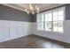 Bright dining room features wainscoting, hardwood floors, and modern light fixture at 111 Gaines Trail, Pittsboro, NC 27312