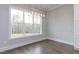 Light-filled dining area featuring hardwood floors, large window, and modern lighting fixture at 111 Gaines Trail, Pittsboro, NC 27312