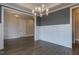 Bright dining room features wainscoting, hardwood floors, and modern light fixture at 111 Gaines Trail, Pittsboro, NC 27312