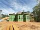 Exterior view of a home featuring a porch and green weather-resistant barriers at 111 Gaines Trail, Pittsboro, NC 27312