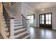 Spacious foyer featuring hardwood floors, a staircase, and decorative lighting at 111 Gaines Trail, Pittsboro, NC 27312
