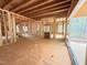 Unfinished interior with exposed framing, open floor plan, and access to an outdoor porch at 111 Gaines Trail, Pittsboro, NC 27312