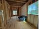 Unfinished interior with exposed framing, featuring insulation and visible plumbing at 111 Gaines Trail, Pittsboro, NC 27312