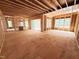 Spacious, unfinished room with exposed wood framing and large windows filling the space with light at 111 Gaines Trail, Pittsboro, NC 27312