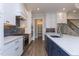 Modern kitchen with stainless steel appliances, blue island, and white cabinets at 111 Gaines Trail, Pittsboro, NC 27312