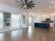 Open-concept living room and kitchen with fireplace and sliding glass doors leading to the patio at 111 Gaines Trail, Pittsboro, NC 27312