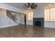Bright living room featuring hardwood floors, fireplace, and custom built-in shelving at 111 Gaines Trail, Pittsboro, NC 27312