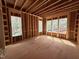 Room under construction features multiple large windows providing ample natural light, enhancing its airy feel at 111 Gaines Trail, Pittsboro, NC 27312
