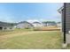 Backyard view featuring newly constructed homes in a neighborhood, with landscaping in progress at 136 Newport Lndg, Garner, NC 27529