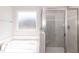 Modern bathroom boasts a soaking tub and glass-enclosed shower at 136 Newport Lndg, Garner, NC 27529
