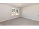 A bedroom that features gray walls and carpeting with a window that allows in ample natural light at 136 Newport Lndg, Garner, NC 27529