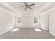 Large bedroom featuring a tray ceiling with fan and abundant natural light at 136 Newport Lndg, Garner, NC 27529