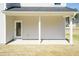 Covered lanai with a white door providing access to the home, supported by white columns at 136 Newport Lndg, Garner, NC 27529