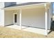 Covered lanai featuring a door providing access to the home and a white support column on a concrete patio at 136 Newport Lndg, Garner, NC 27529