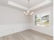 Elegant dining room with a modern chandelier, wainscoting, and large windows, perfect for entertaining at 136 Newport Lndg, Garner, NC 27529