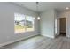 Light-filled dining room with large windows overlooking backyard and wood-look flooring at 136 Newport Lndg, Garner, NC 27529
