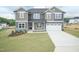 Charming two-story home with a well-manicured lawn and a two-car garage showcasing its appealing curb appeal at 136 Newport Lndg, Garner, NC 27529