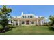 An exterior of a clubhouse with a light trim, set against a large green lawn at 136 Newport Lndg, Garner, NC 27529
