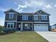 Inviting two-story home featuring a two-car garage and a well-manicured front lawn at 136 Newport Lndg, Garner, NC 27529