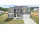 Front exterior showcasing a two-story home, gray siding, two-car garage and a well manicured lawn at 136 Newport Lndg, Garner, NC 27529