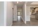 Open hallway with wood floors, leading to a modern kitchen and inviting living spaces enhancing the home's flow at 136 Newport Lndg, Garner, NC 27529