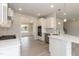 Bright kitchen with white cabinets, stainless steel appliances, and quartz countertops at 136 Newport Lndg, Garner, NC 27529