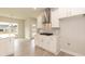 Bright kitchen featuring white cabinets, stainless vent hood, and a gas cooktop at 136 Newport Lndg, Garner, NC 27529